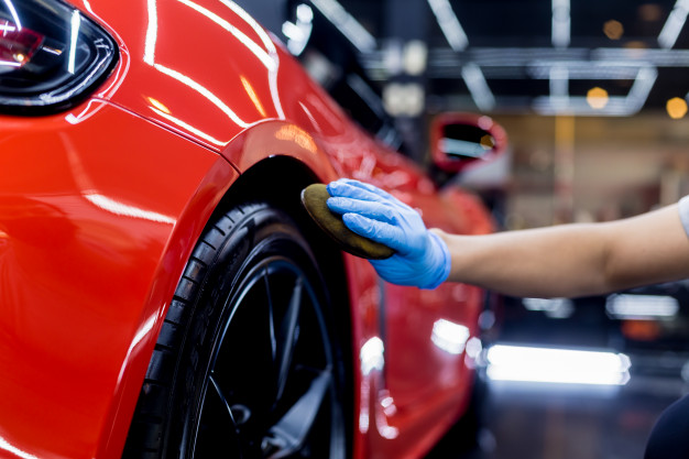 car service worker polishing car wheels with microfiber cloth 179755 6551